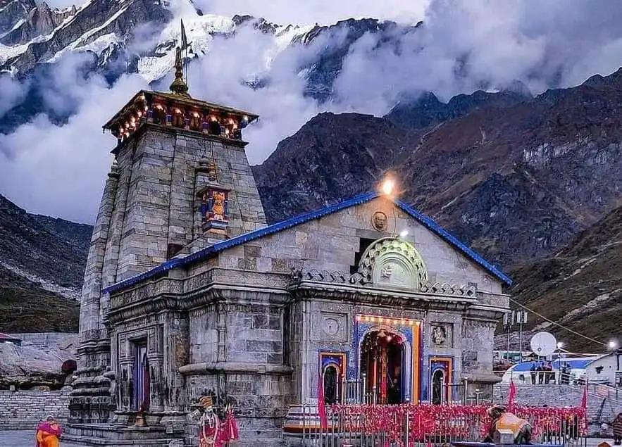 Devotees offering prayers and performing rituals inside Kedarnath Temple, immersed in a spiritual ambiance.