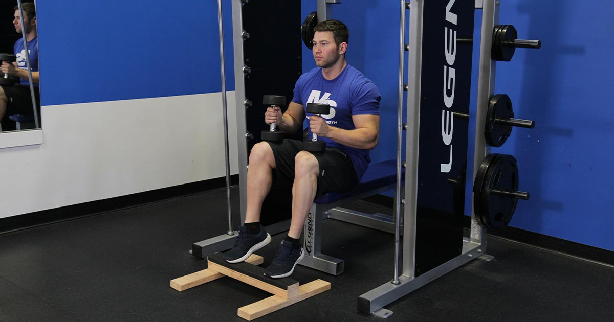 Man performing seated calf raises exercise